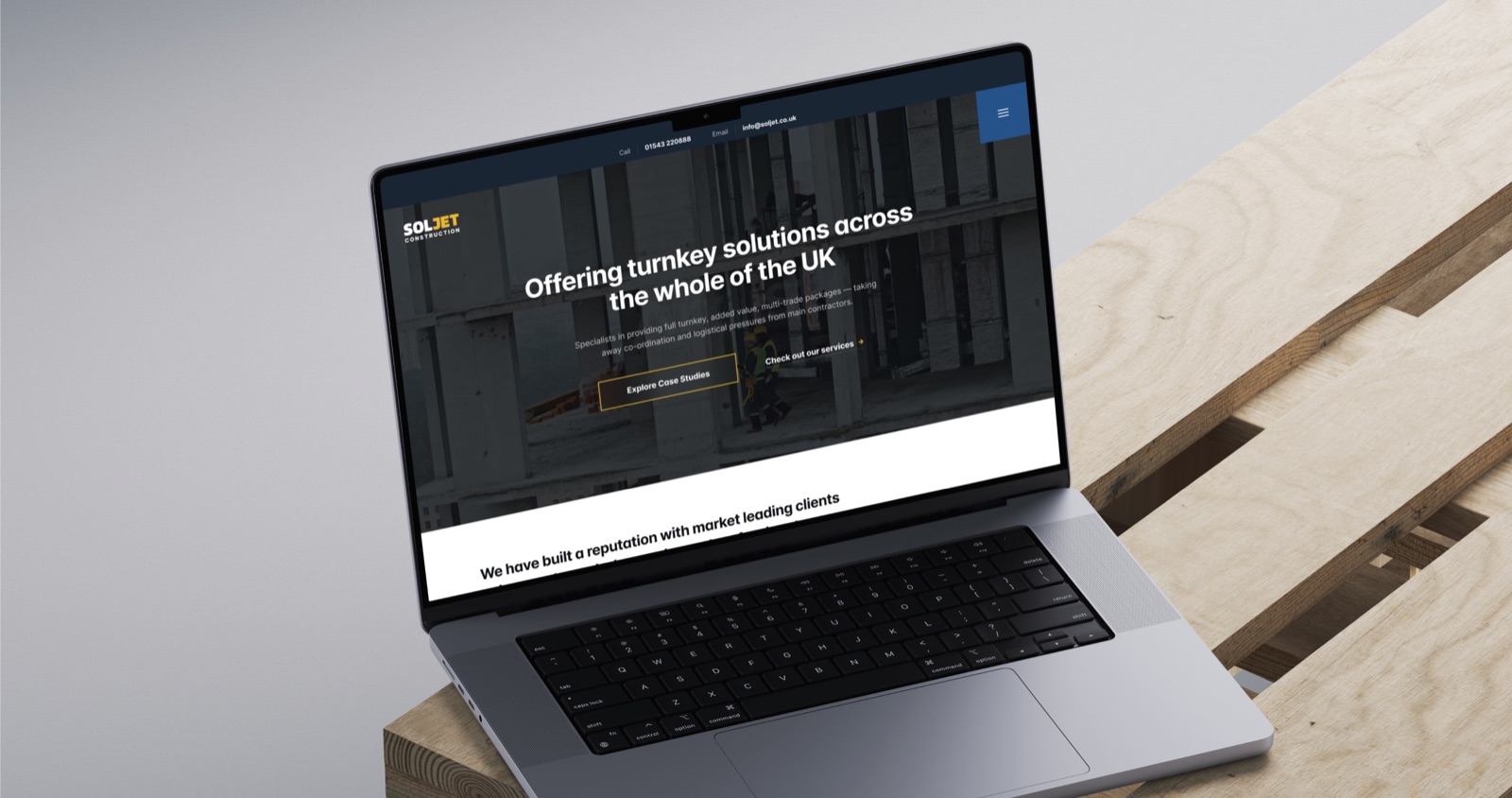 The SOLJET construction website shown on a laptop